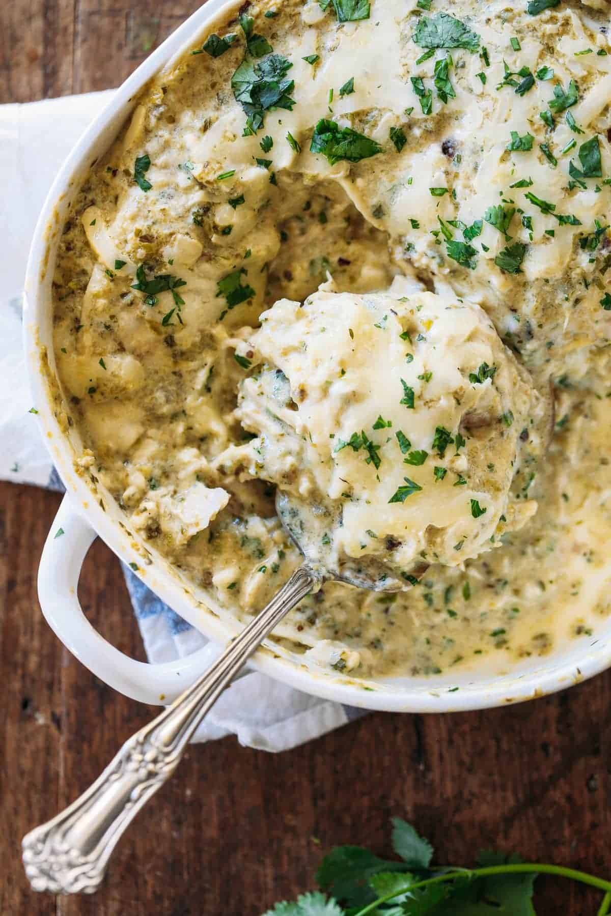 Roasted Tomatillo Chicken Enchilada Casserole in a white baking dish.